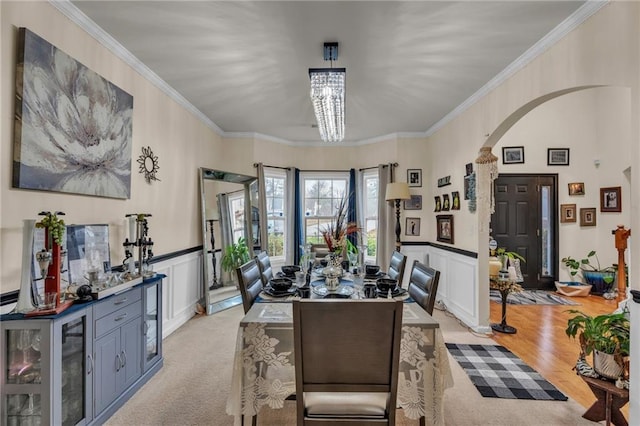 dining area with ornamental molding and a chandelier