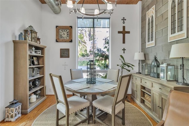 dining area featuring a chandelier and light wood finished floors