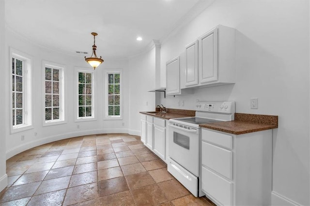 kitchen featuring baseboards, dark countertops, and white range with electric cooktop