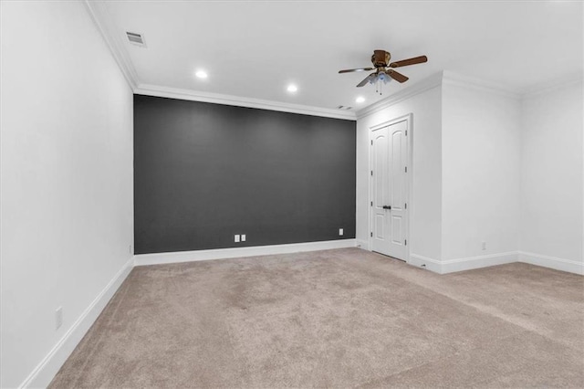 empty room with baseboards, carpet floors, visible vents, and a ceiling fan