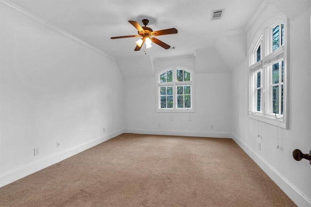 spare room featuring baseboards, ceiling fan, visible vents, and light colored carpet