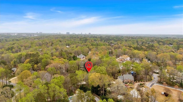 birds eye view of property with a view of trees