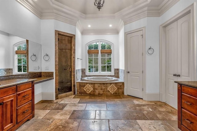 bathroom featuring a bath, crown molding, vanity, stone tile flooring, and a stall shower