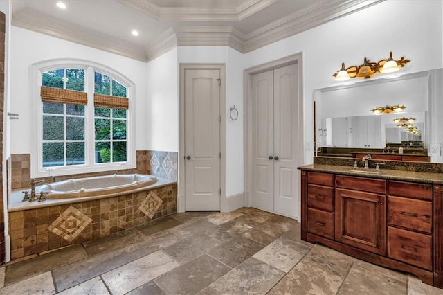 bathroom with a bath, vanity, crown molding, and stone tile flooring