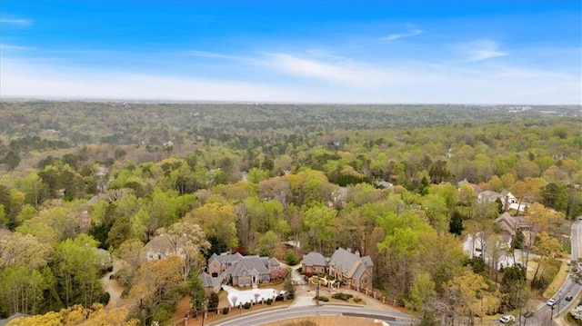 drone / aerial view featuring a wooded view