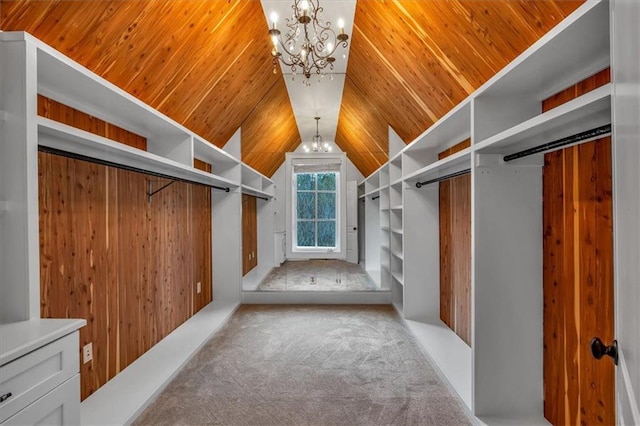 spacious closet featuring carpet flooring, lofted ceiling, and a notable chandelier