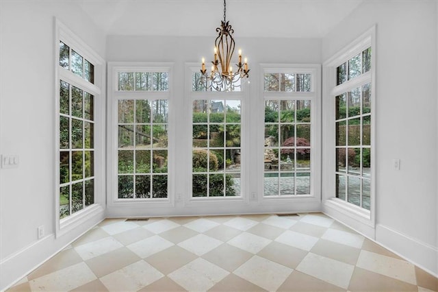 unfurnished sunroom with a wealth of natural light and a notable chandelier