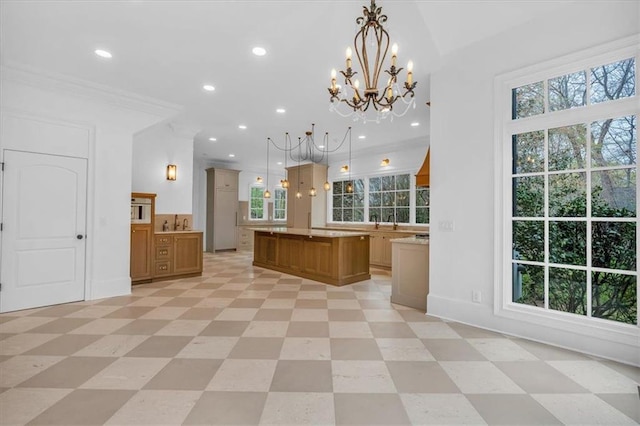 kitchen with light countertops, pendant lighting, a chandelier, and recessed lighting