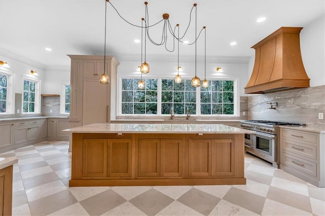 kitchen with plenty of natural light, range with two ovens, custom exhaust hood, and light floors