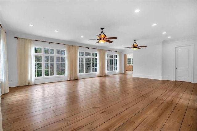 unfurnished living room featuring light wood-style flooring, a healthy amount of sunlight, and recessed lighting