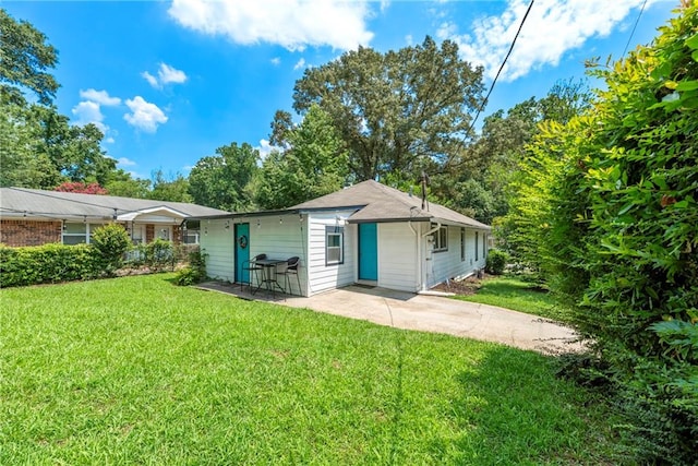 back of property featuring a lawn