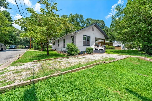 view of side of home with a lawn