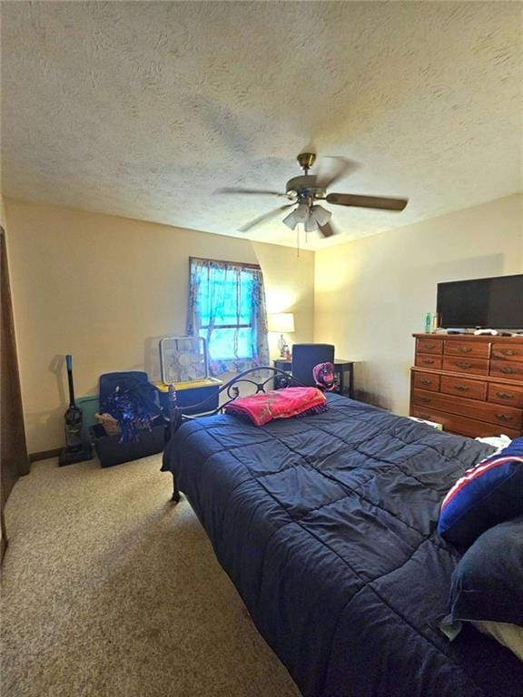 bedroom featuring a textured ceiling, carpet floors, and ceiling fan