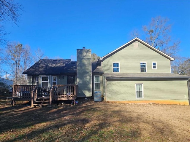 back of house featuring a deck, a yard, and central AC