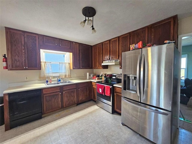 kitchen with a textured ceiling, sink, and appliances with stainless steel finishes