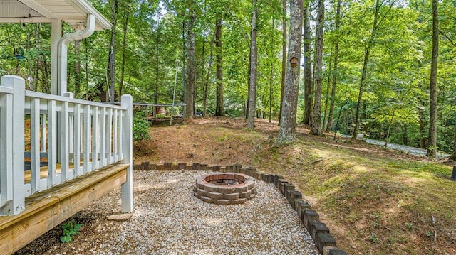 view of yard with an outdoor fire pit and a deck