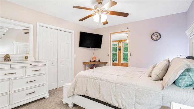 carpeted bedroom with ceiling fan and a closet