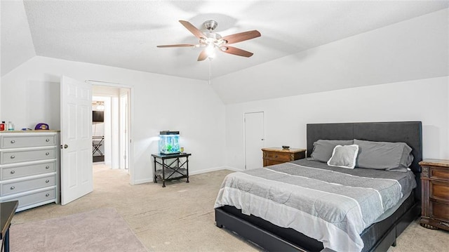 carpeted bedroom featuring vaulted ceiling and ceiling fan