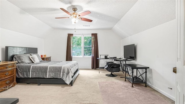 carpeted bedroom featuring a textured ceiling, vaulted ceiling, and ceiling fan