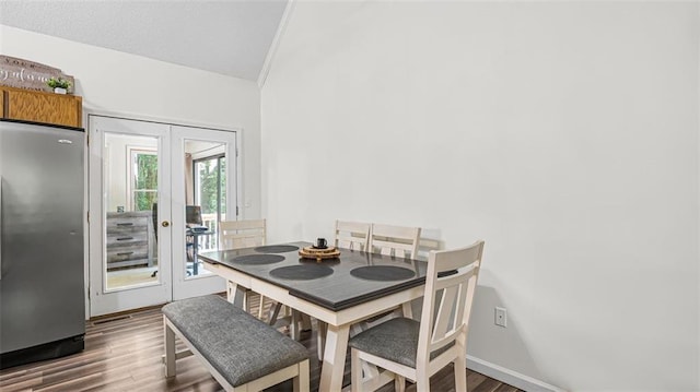 dining space featuring french doors and dark hardwood / wood-style flooring