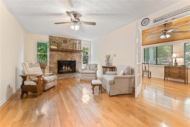 479 Deerpath Dr, Sautee Nacoochee, GA 30571 - living room with a ceiling fan, a textured ceiling, wood finished floors, and a fireplace