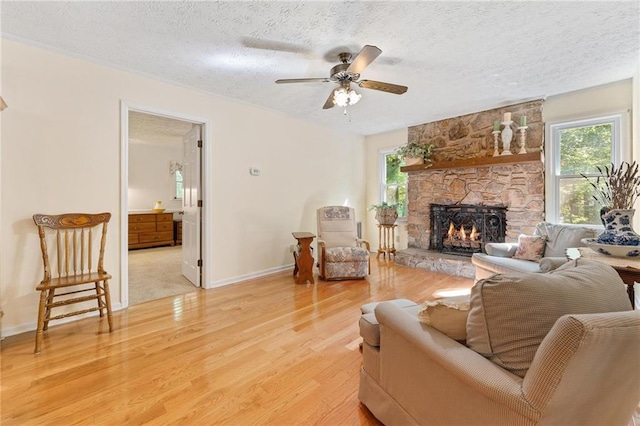 479 Deerpath Dr, Sautee Nacoochee, GA 30571 - living area featuring a textured ceiling, a fireplace, light wood finished floors, and ceiling fan