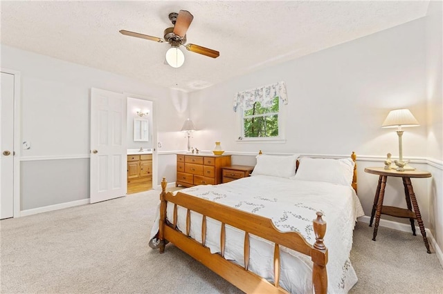 479 Deerpath Dr, Sautee Nacoochee, GA 30571 - bedroom with light colored carpet, a textured ceiling, connected bathroom, and a ceiling fan