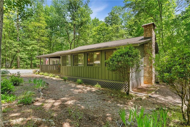 479 Deerpath Dr, Sautee Nacoochee, GA 30571 - view of front of house with a chimney, board and batten siding, driveway, and roof with shingles