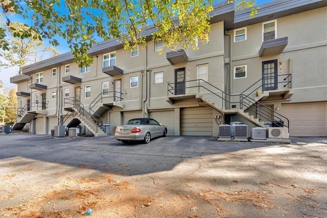 view of building exterior featuring central air condition unit, ac unit, and a residential view