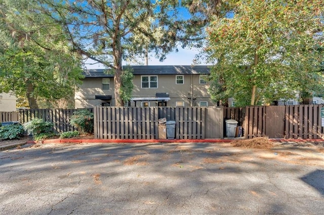 view of front of house with fence and stucco siding