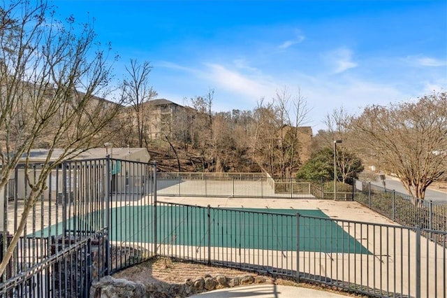 community pool featuring fence and a patio