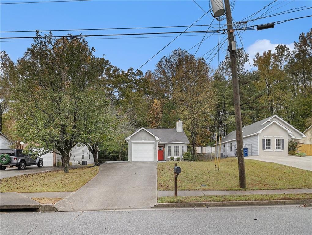 view of front of property with a front yard and a garage