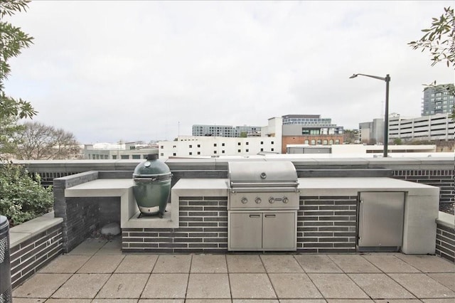 view of patio featuring area for grilling and a grill