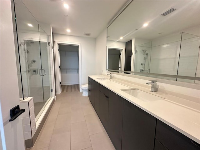 bathroom with recessed lighting, tile patterned floors, a shower stall, and a sink