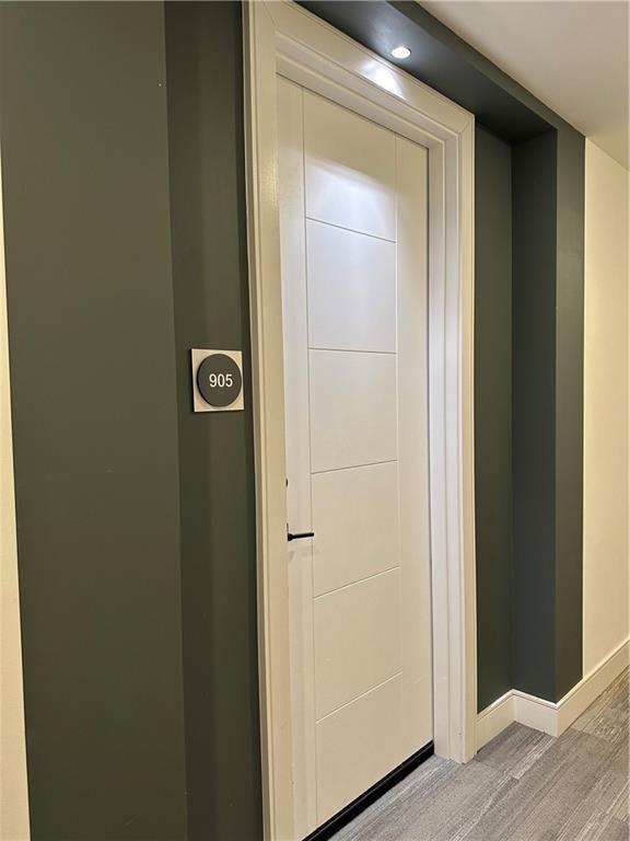 interior space featuring baseboards and wood finished floors