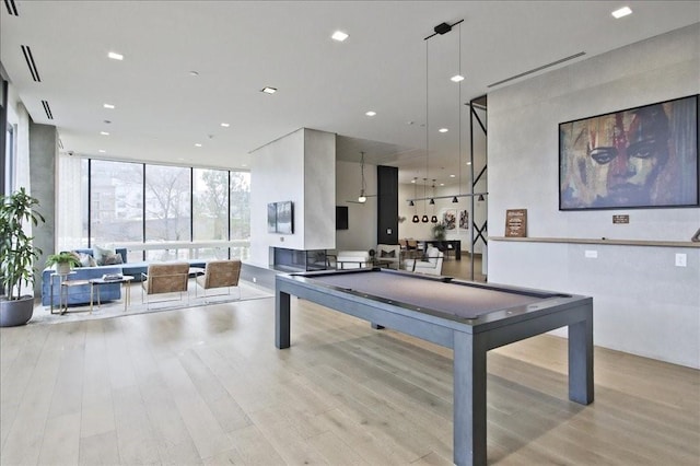 game room featuring recessed lighting, billiards, expansive windows, and wood finished floors