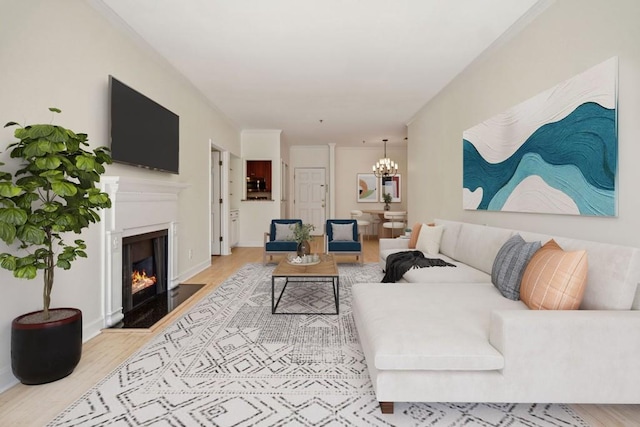 living room featuring baseboards, a fireplace with flush hearth, a chandelier, and wood finished floors