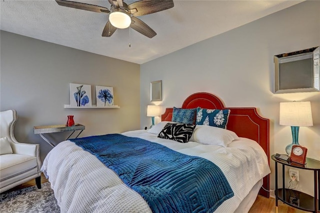 bedroom with a ceiling fan and wood finished floors