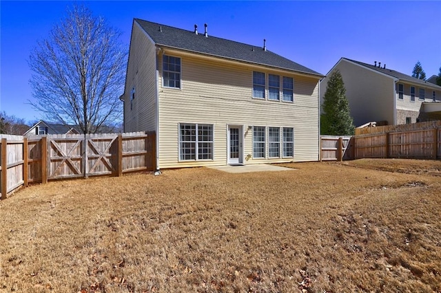 back of property featuring a fenced backyard and a patio area