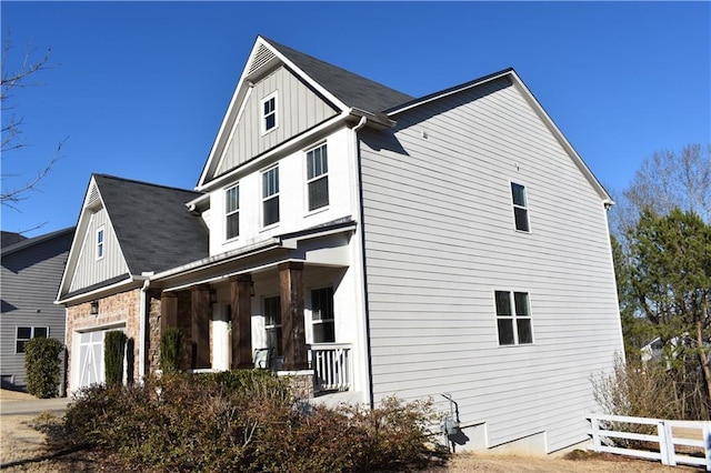 view of property exterior featuring a garage and covered porch