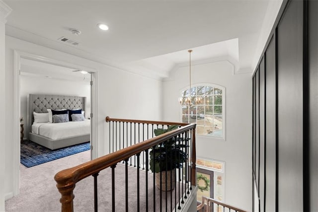 hall with vaulted ceiling, light carpet, and a notable chandelier