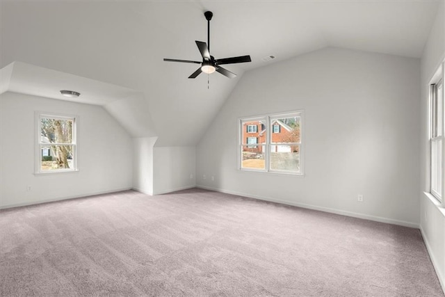 bonus room with lofted ceiling, plenty of natural light, and light colored carpet