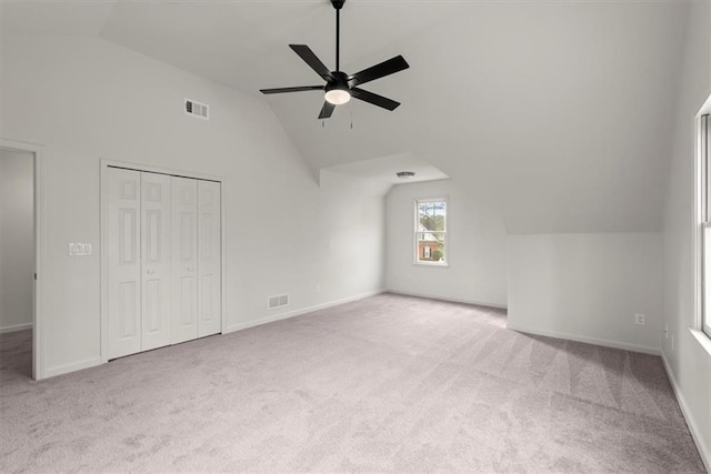 bonus room featuring lofted ceiling, light carpet, and ceiling fan