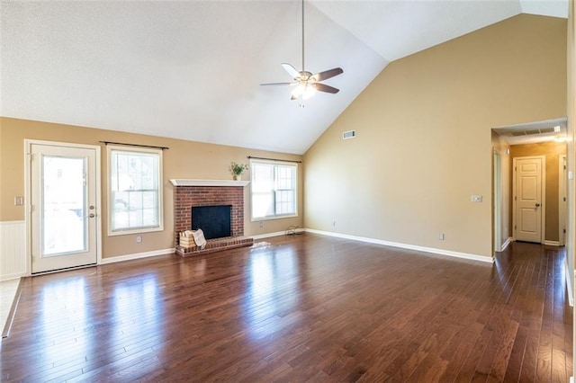 unfurnished living room featuring baseboards, a ceiling fan, dark wood-style floors, a fireplace, and high vaulted ceiling