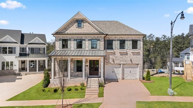 view of front facade featuring a garage, a front yard, and a porch