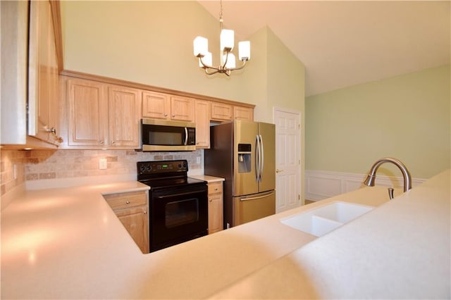 179 Camry Ln, Grayson, GA 30017 - kitchen featuring stainless steel appliances, a sink, a chandelier, light brown cabinetry, and light countertops