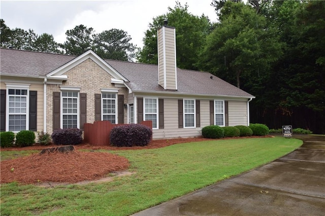 179 Camry Ln, Grayson, GA 30017 - view of property exterior featuring a chimney, a lawn, and roof with shingles