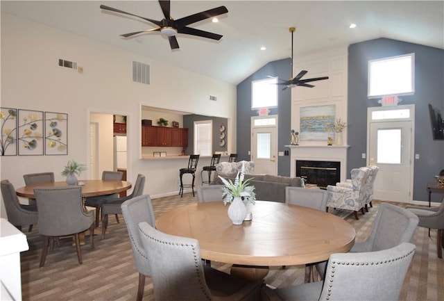 179 Camry Ln, Grayson, GA 30017 - dining room with a ceiling fan, high vaulted ceiling, a fireplace, baseboards, and recessed lighting