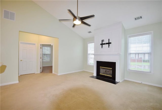 179 Camry Ln, Grayson, GA 30017 - unfurnished living room with light carpet, a ceiling fan, a large fireplace, baseboards, and high vaulted ceiling