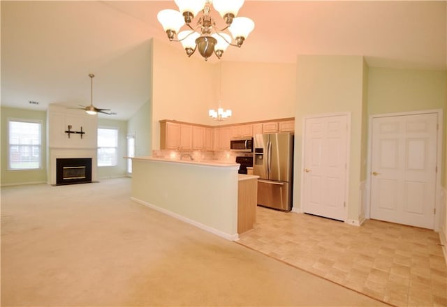 179 Camry Ln, Grayson, GA 30017 - kitchen with appliances with stainless steel finishes, a chandelier, high vaulted ceiling, baseboards, and pendant lighting